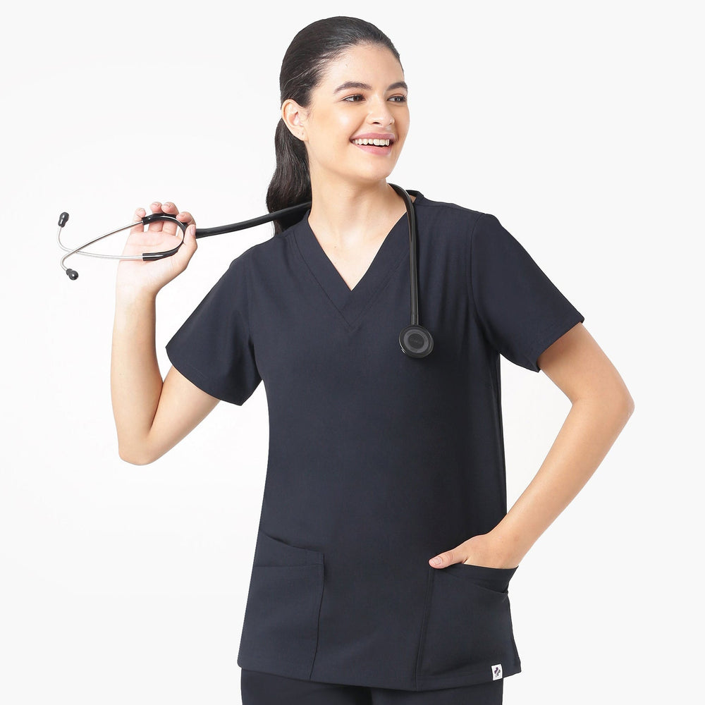 Person wearing black medical scrubs holding a stethoscope on a white background